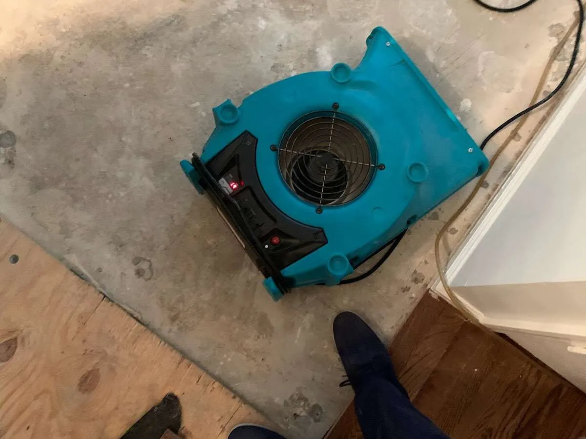 Air mover drying subfloor during Commercial Water Damage Restoration in Northwood